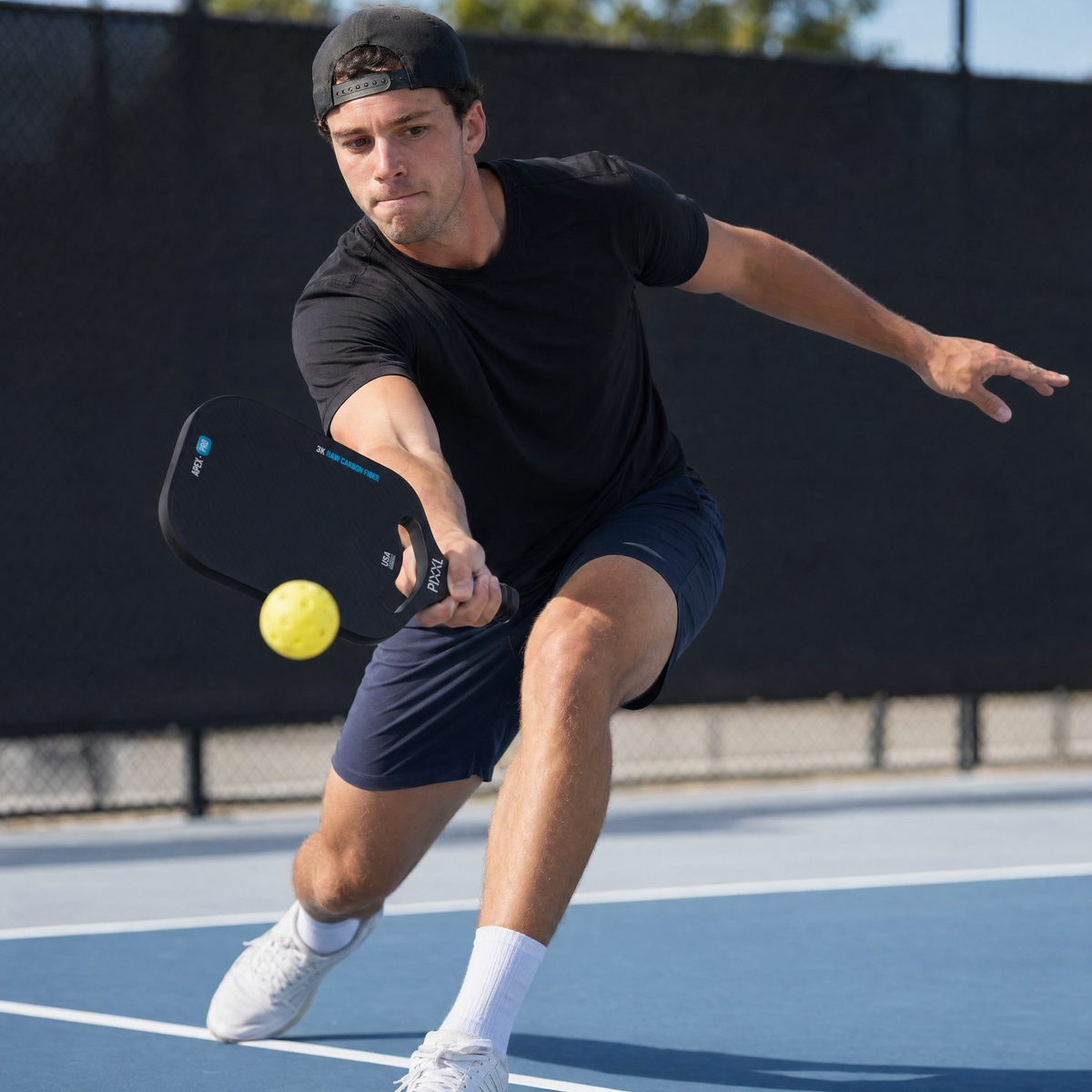 Player mid-swing with paddle