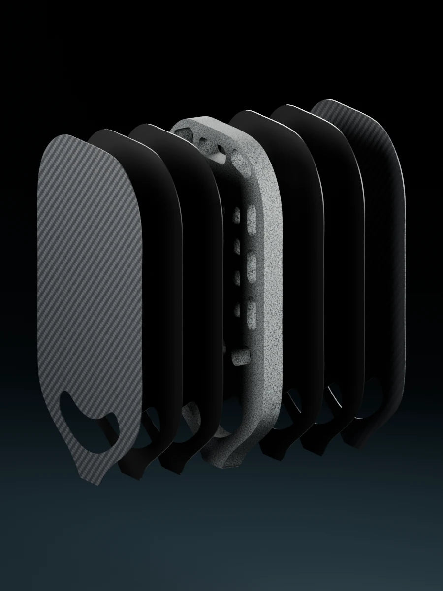Exploded paddle showing three separated face plies on each side of the gray foam core